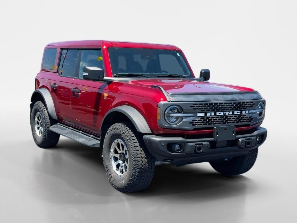 2025 Ford Bronco Badlands in Ruby Red Metallic Tinted Clearcoat — front three-quarter view